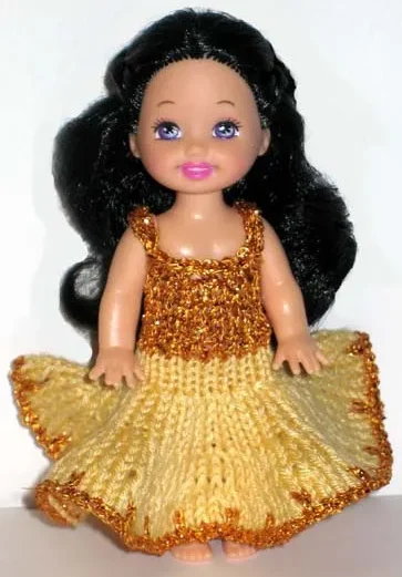 Barbie i gul klänning med glittrig guldöverdel.